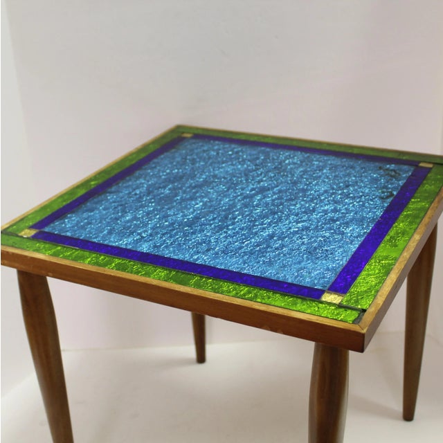 Square top with blue and green colored glass in simple square design, tapers solid wood legs, lightweight. Great for...