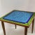 Square top with blue and green colored glass in simple square design, tapers solid wood legs, lightweight. Great for...