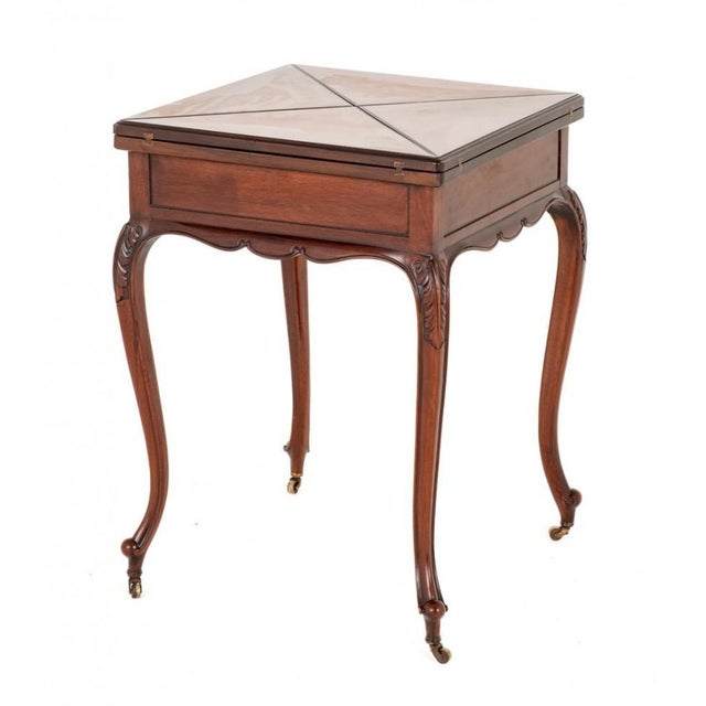 Pretty late Victorian mahogany envelope card table. This table stands upon shaped legs with carved toes and brass castors....