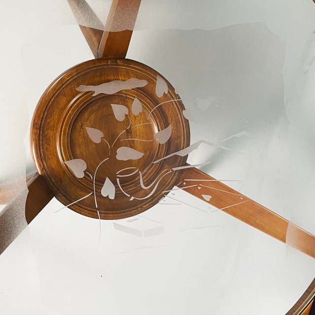 Italian mid-century modern coffe table in wood and decorated glass, 1950s Coffee table with round decorated glass top and...