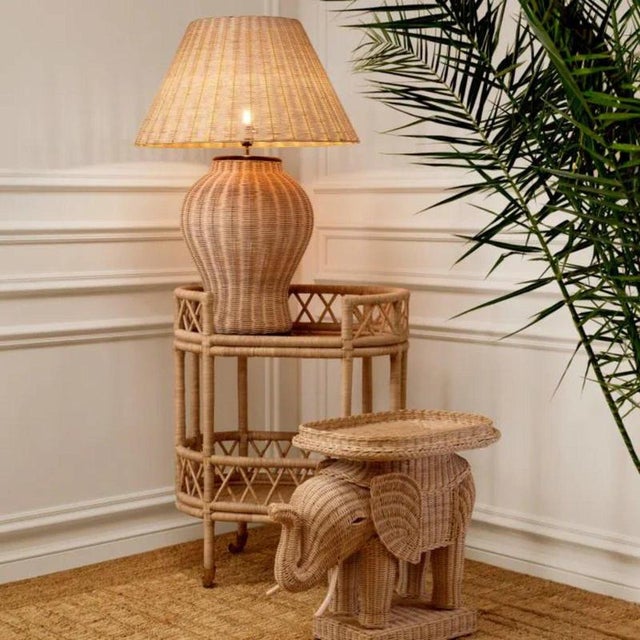 Natural rattan side table with a sculptural elephant-shaped silhouette, combining practical function with a distinctive...