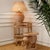 Natural rattan side table with a sculptural elephant-shaped silhouette, combining practical function with a distinctive...