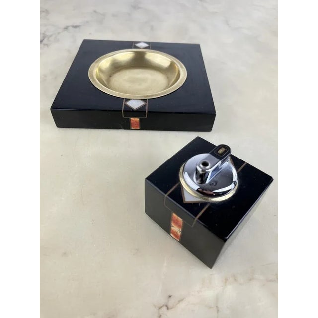 Vintage Set of 2 Italian design ashtrays and table lighters from the 70s. The ashtray is made of brass and decorated wood....