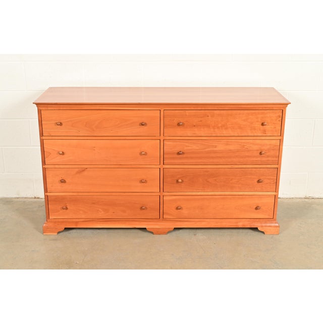 A beautiful Arts and Crafts or Shaker style solid cherry wood eight-drawer dresser By Harden Furniture USA, Circa Late...