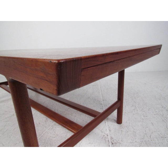 Well constructed Danish modern table with two 16.75" hidden extension leaves which can be opened independently or together...