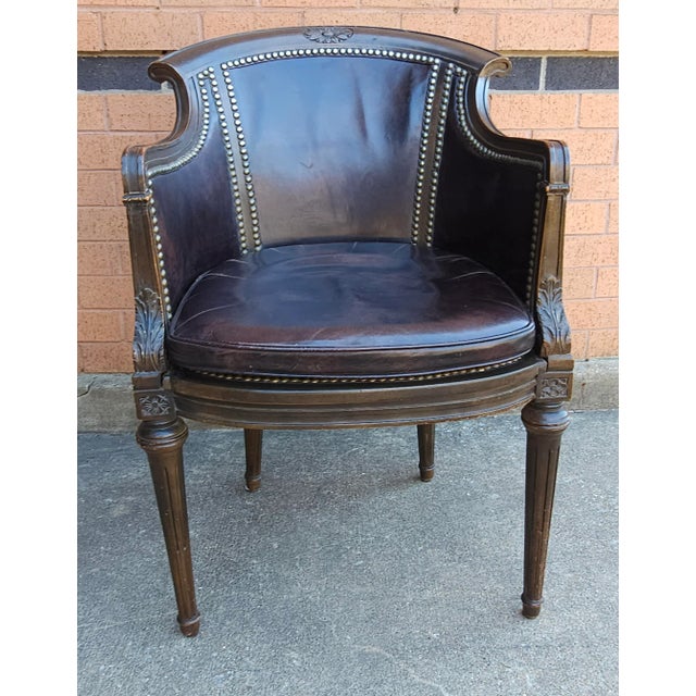 A Mid Century Empire Style full grain Leather Upholstered and Nailhead Studded Mahogany Arm Chair. Measures 22" in width,...