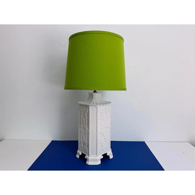 Stunning tall pagoda lamp by Chapman of glazed white porcelain accented by a fluted top with raised fretwork panels and...