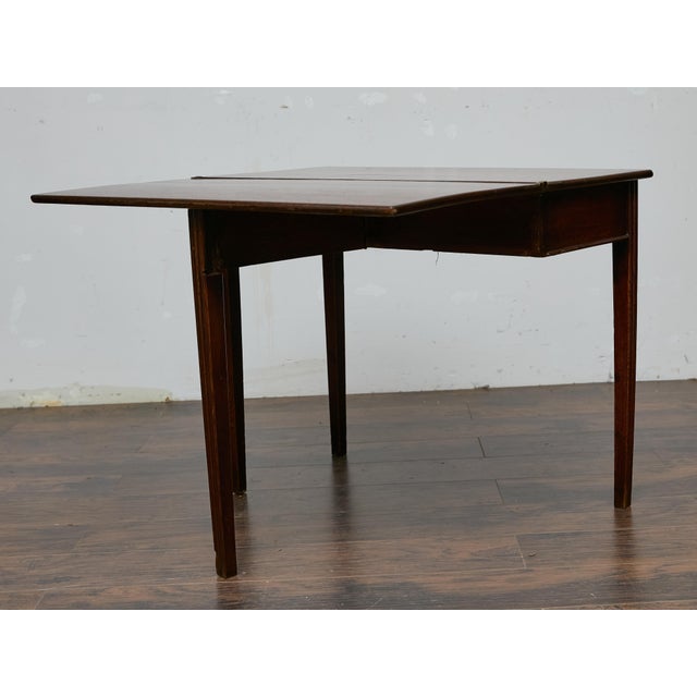 This English oak table, circa 1800, is a fine example of Georgian-period craftsmanship, blending refined simplicity with a...