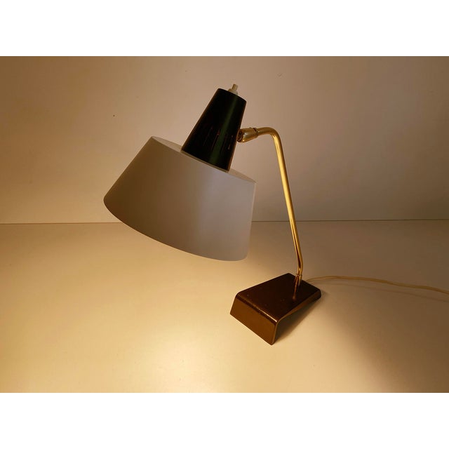 Kaiser Desk lamp, Modell 6813, 1960s, featuring a cantilivered black enameled cast iron base, brass stem and superimposed...