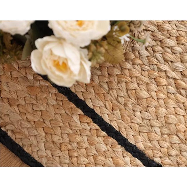 Hand-woven from natural jute, with a beige texture as the base and outlined with a double-layered black border.