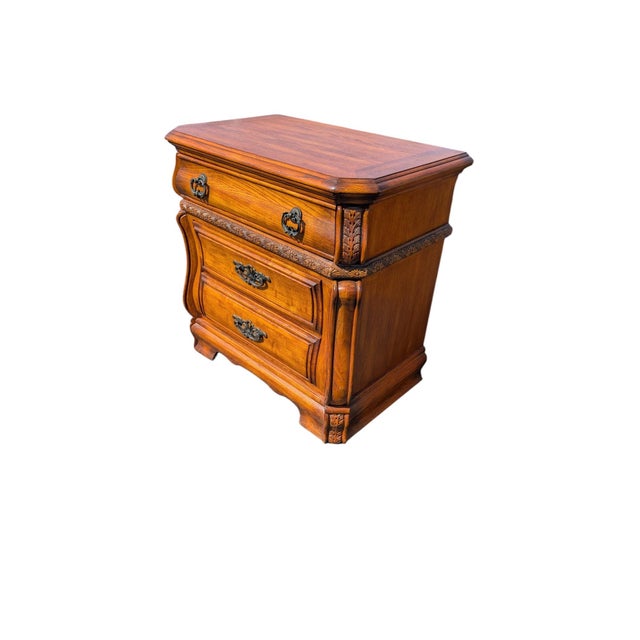 A beautifully matched pair of vintage French Provincial bombé nightstands — the kind of pieces that quietly elevate a...