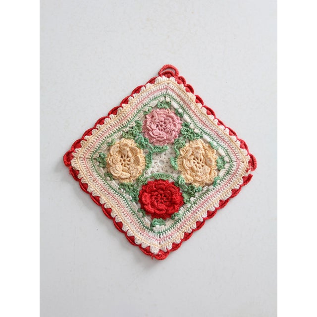 1940s vintage crochet potholder featuring a handmade square design with four rosettes at the center. Crafted in vibrant...