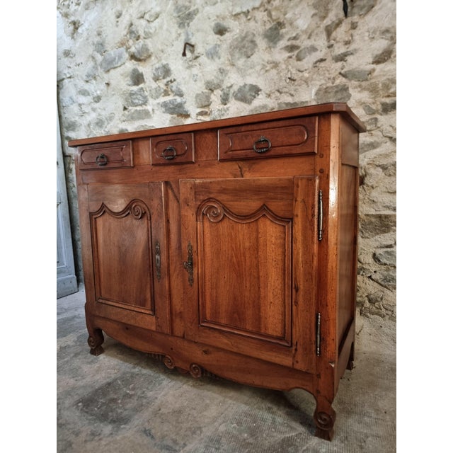 French sideboard dating from the late 19th century. Made of solid walnut, this cabinet features a restrained Louis XV...