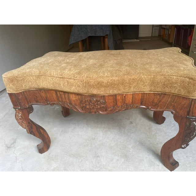 Antique serpentine mahogany fireside bench. Probably from the 1900's possibly French. Ornate floral carving on the...