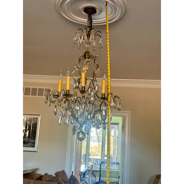 It features the sinuous, asymmetrical, and ornate curves associated with the Rococo style of the Louis XV period. It is a...