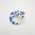 This resin cast artwork depicts a whimsical salamander adorned with intricate blue and white patterns reminiscent of...