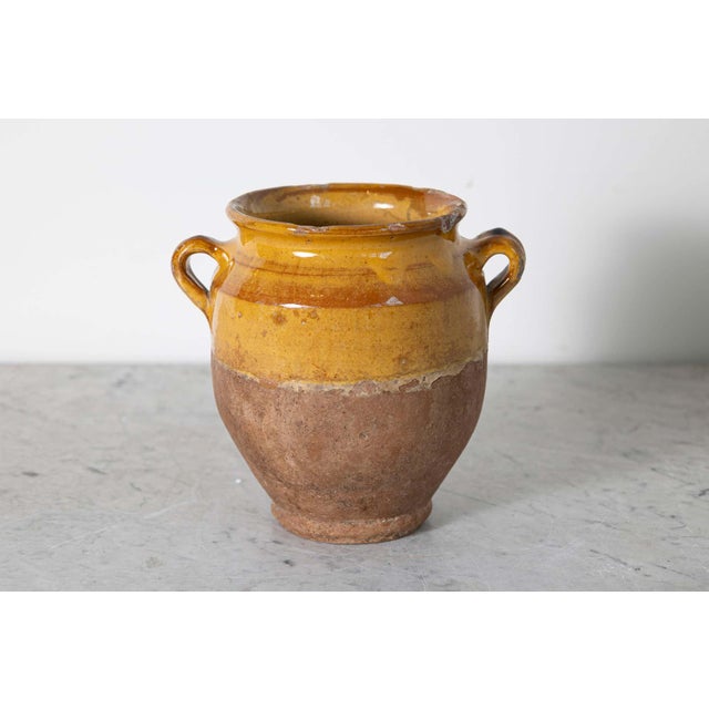 This 19th-century Spanish pottery jar beautifully captures the rustic charm and artisanal craftsmanship of the...