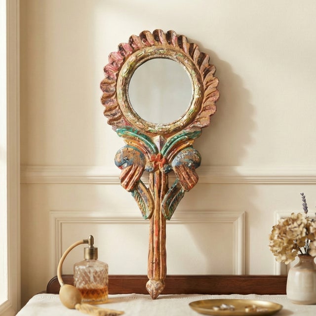 Dimensions: 3" W x 13" D x 1" H A beautifully hand carved vintage hand held mirror. It wears its original painted patina....
