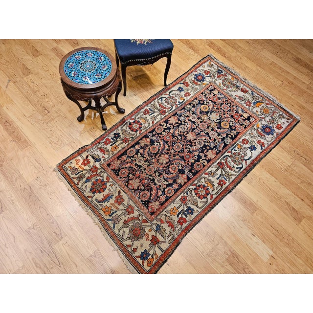 This exquisite early 20th-century Persian Malayer rug showcases an allover Herati geometric pattern woven in a deep navy...