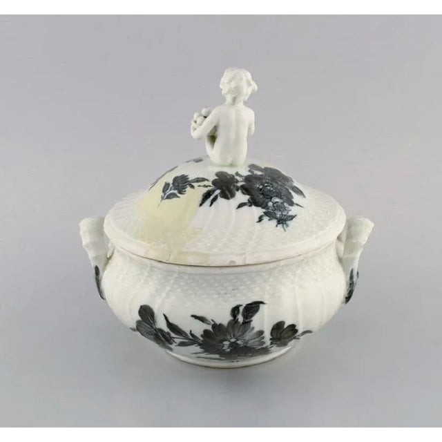 Early Royal Copenhagen blue flower curved lidded tureen in porcelain with hand-painted flowers. Lid modelled with fruit-...