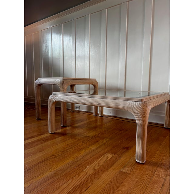 Beautiful vintage 1970s pair of sculptural pencil reeded rattan tables, featuring a distinctive waterfall silhouette and...