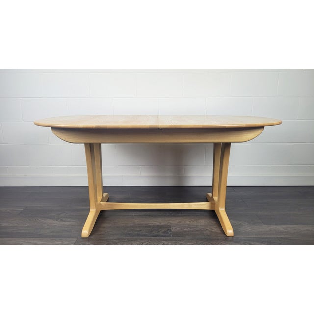 - Ash wood extending dining table - Produced by Ercol during the 2000s - Top is refinished in our own workshop and base is...