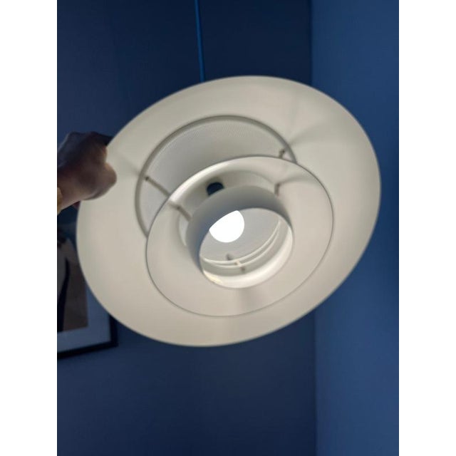 The Safari pendant lamp in white was designed by the design trio Christian Hvidt, Peter Hvidt, and Orla Mølgaard-Nielsen...