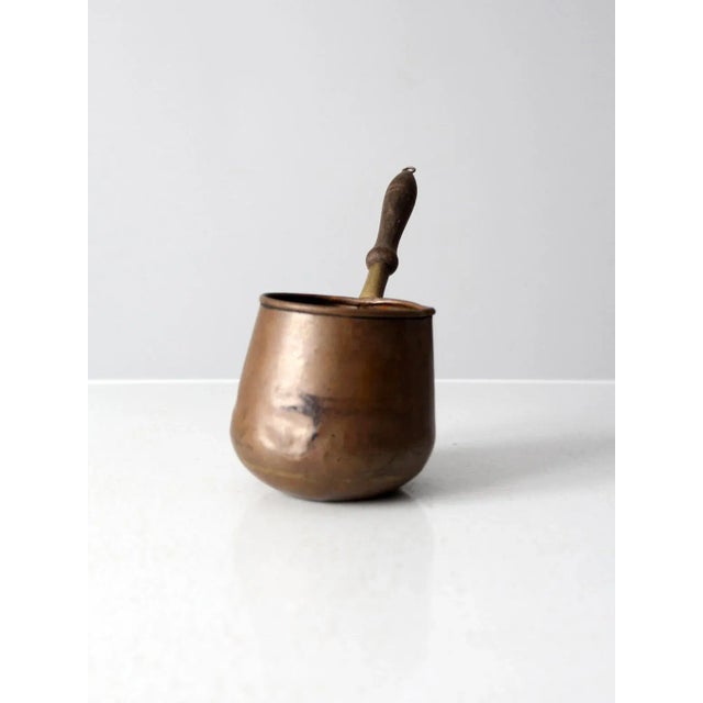 Here is an antique Turkish copper coffee pot. Many uses in the kitchen including warming butter, rum or ale, or browning...