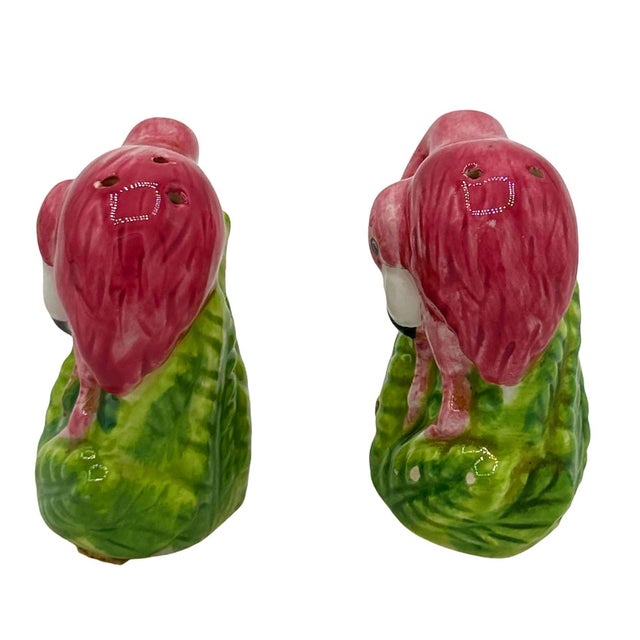 Mid-century pink and green ceramic flamingo tabletop salt & pepper shaker set. The set features two beautifully detailed...
