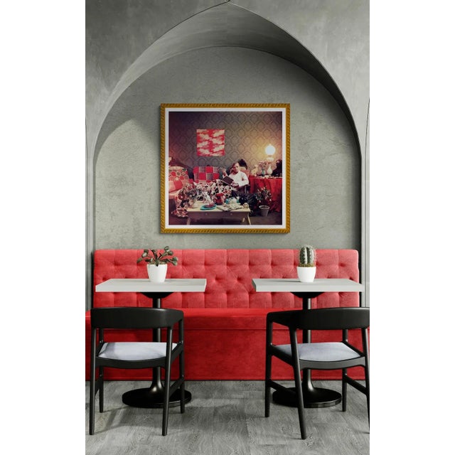 Truman Capote relaxes with a book and a cigarette in his cluttered apartment, Brooklyn Heights, New York. As an authorized...