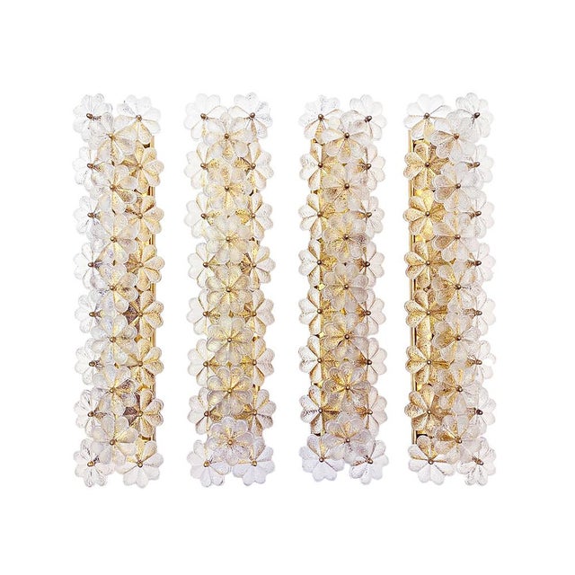 A set of 4 of extremely rare, enormous wall sconces featuring twenty-three overlapping flowers made of clear glass,...