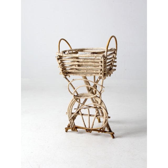 This is an antique Adirondack twig table plant stand. Creamy white and yellow paint colors this American rustic planter,...
