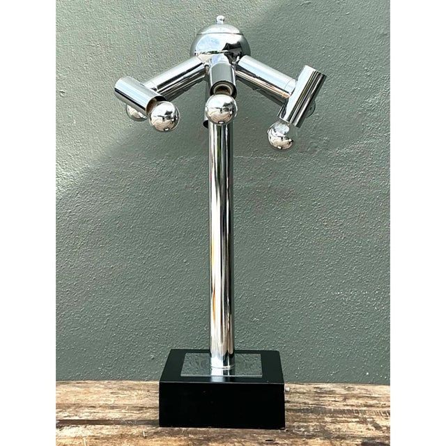 This vintage modernist table lamp, created in the style of Robert Sonneman, presents a striking atomic-age sculptural...