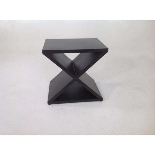 Modern end table. Table is made if iron with dark finish. Table is quite unique and in excellent condition.