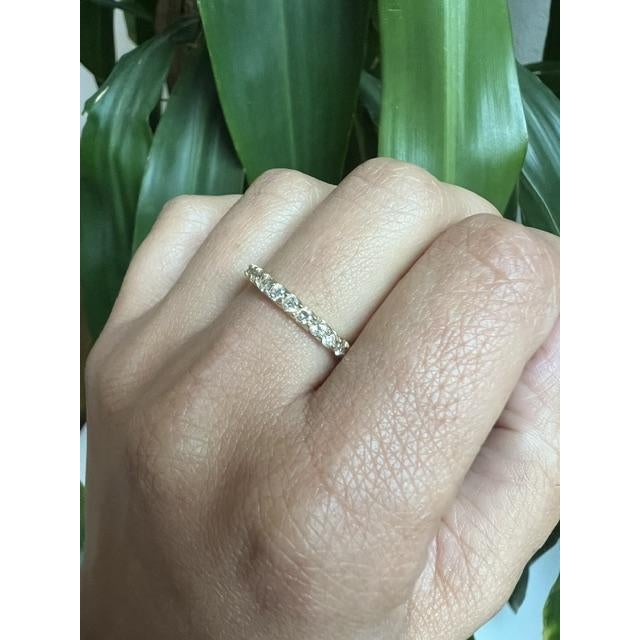 Elegant 0.50 Carat Round Cut Diamond 14 Karat Yellow Gold Band Ring This band ring features round cut diamonds with a...