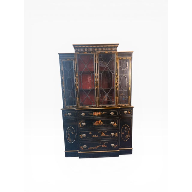 A striking chinoiserie-style breakfront cabinet by Union National, finished in a rich black lacquer with finely detailed...