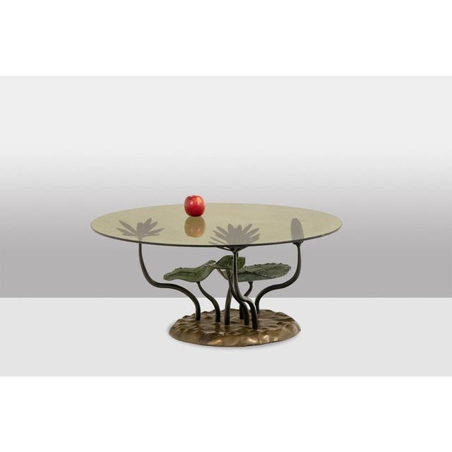 “Water Lily” coffee table in bronze with two patinas—green and gold—featuring a water lily design, with a round smoked...