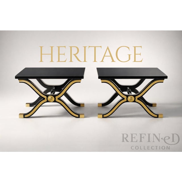 A bold and elegant pair of Hollywood Regency–style side tables by Heritage Furniture, each clearly marked with the...