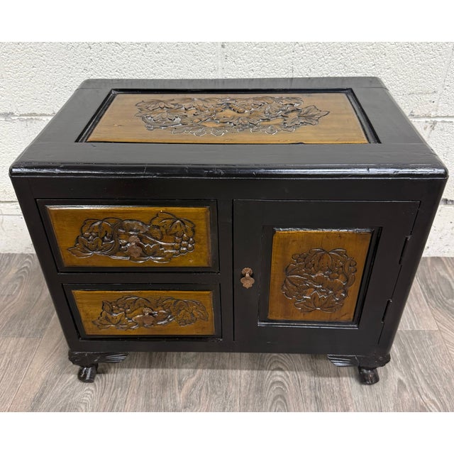 This is a charming early 20th century Asian carved cabinet featuring hand-carved grapevine and squirrel motifs across the...