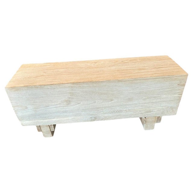 Reclaimed teak wood log bench floating six inches off the floor. Bleached to a bone finish and with an iron brush...