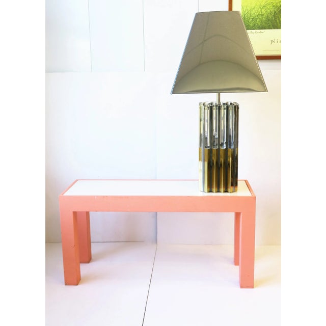 A beautiful, rare, and chic '70s modern brass, chrome, and Lucite table lamp, circa 1970s. In the style of designer...