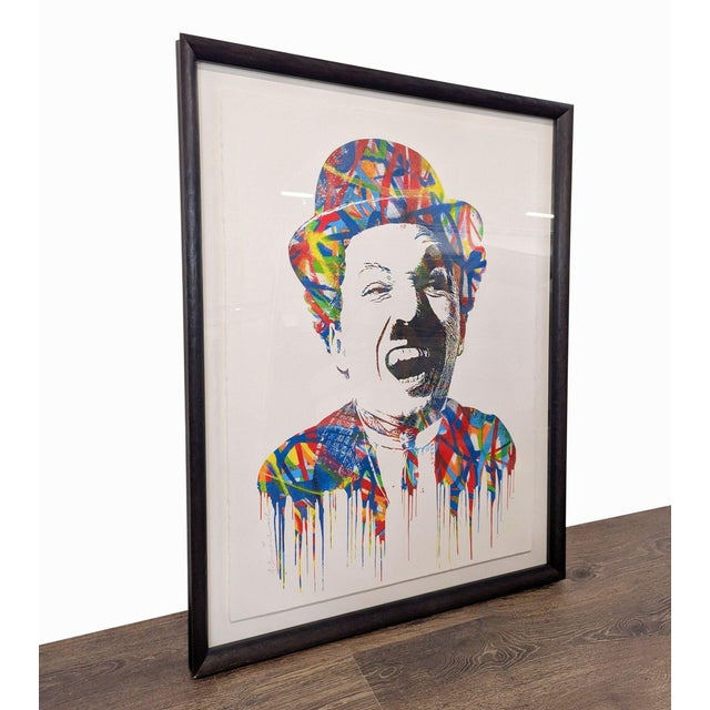 This unique piece features a vibrant, colorful portrait with dynamic splashes and drip effects, creating a lively and...