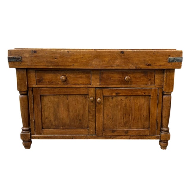 French 19th Century butcher table. Featuring a solid wood top, two drawers, and two cabinet doors with original metal...