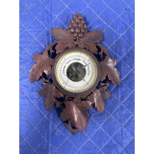 Bring a touch of Old World charm to your home with this exquisite antique Black Forest aneroid barometer, intricately...
