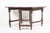 An oak gate-leg, drop-leaf table with rich, dark oak patina, a large oval top, barley-twist turned legs joined by...