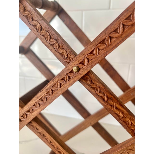 This beautiful wine rack is hand carved from India. The rack will hold 10 bottles of wine and collapses flat when not in...
