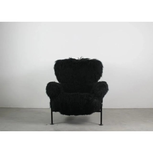 Pl19 also known as tre pezzi armchair with black enameled steel tube structure, upholstered in black mongolian goat wool....