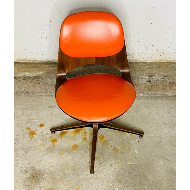Mid Century Modern Dining Room Chair by George Mulhauser for Plycraft. The chair is made of walnut wood and orange vinyl....
