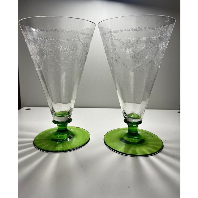 This ring like a bell. Thin walled paneled crystal with swags of floral needle etch tall tumblers with green foot are to...