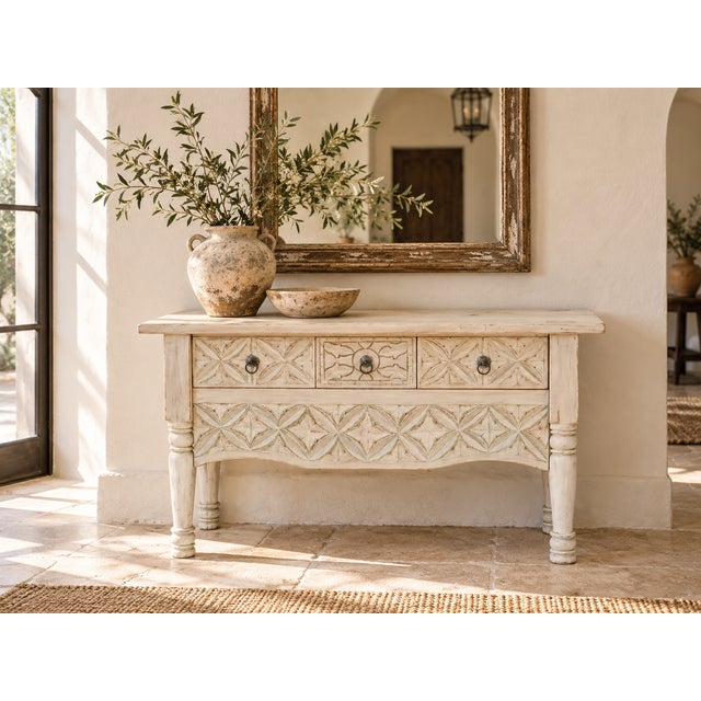 Geometric carving covers the drawer fronts and the shaped apron of this console, star and leaf patterns cut deep enough to...